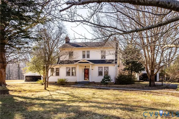 a view of a white house with a yard covered with snow in front of house