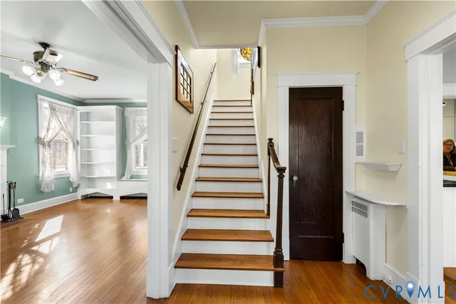 a view of an entryway with wooden floor and stairs