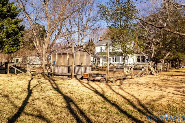 a kitchen with stainless steel appliances granite countertop a refrigerator a sink dishwasher a stove and white countertops with wooden floor