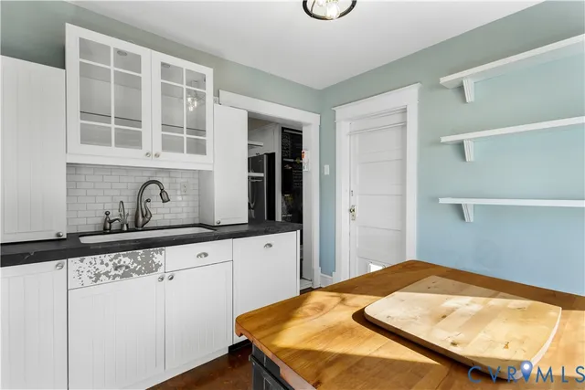 a view of a livingroom with wooden floor and a window