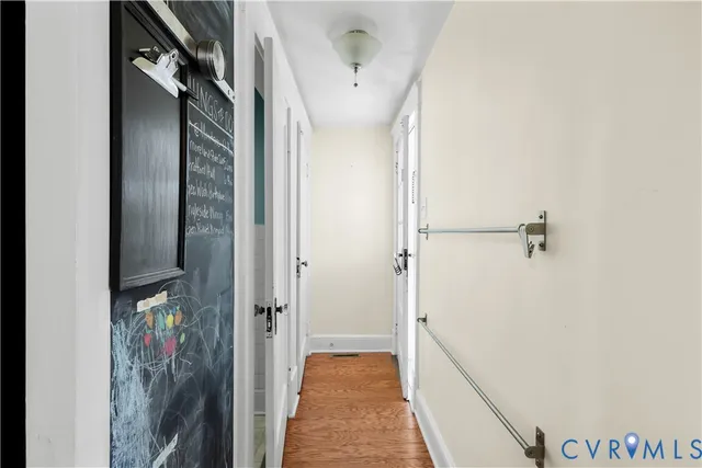 a view of a room with wooden floor and brick walls