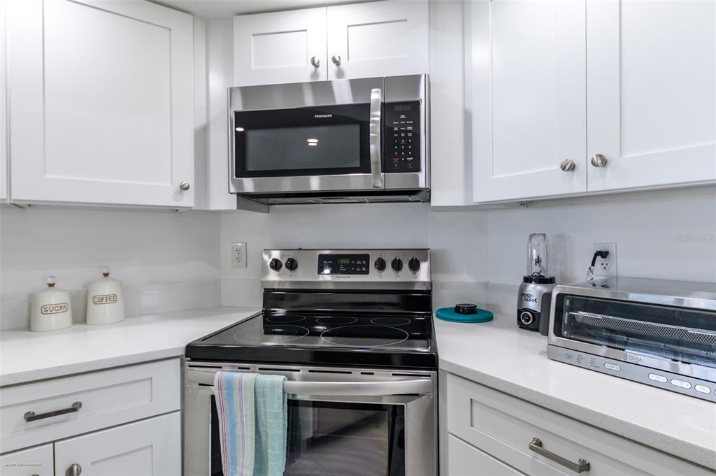 2601 West Marion Avenue, Unit 41C Punta Gorda, FL 33950 - Photo 11 of 43 a kitchen with stainless steel appliances granite countertop white cabinets and a stove a oven with white countertops