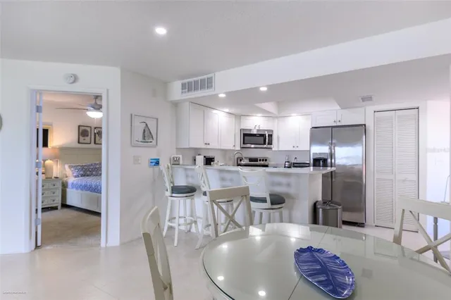 a living room with furniture and a kitchen