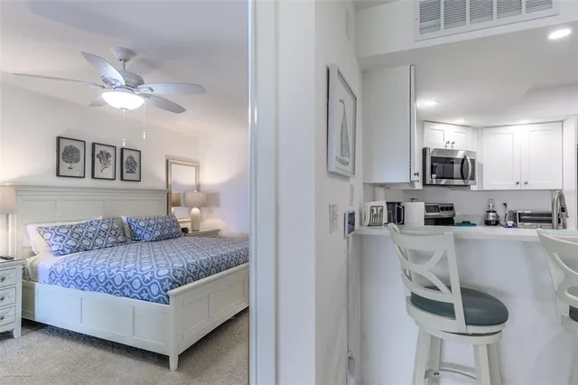 a en suite bathroom with a granite countertop sink and a mirror