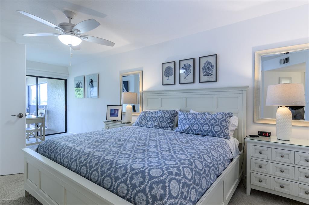 2601 West Marion Avenue, Unit 41C Punta Gorda, FL 33950 - Photo 21 of 43 a bedroom with a large bed and a chandelier