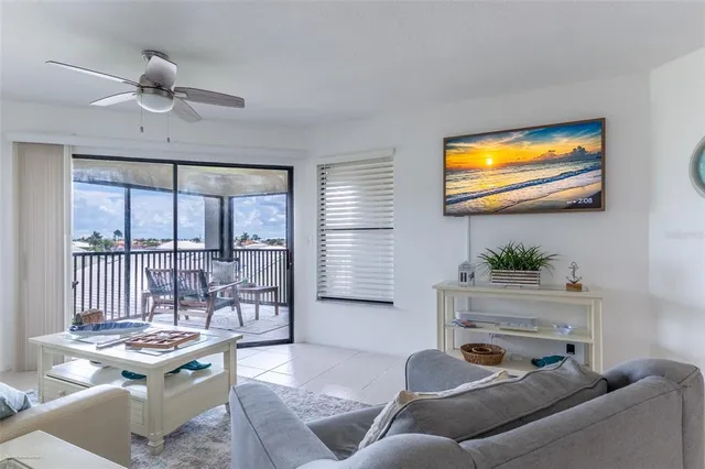 a view of a room with furniture and large windows