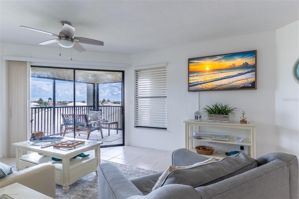 2601 West Marion Avenue, Unit 41C Punta Gorda, FL 33950 - Photo 24 of 43 a living room with furniture and a flat screen tv