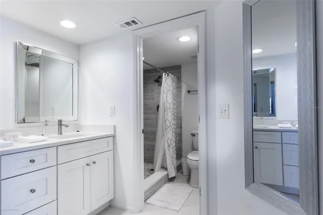 a bathroom with double vanity sinks and a mirror