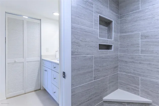 a bathroom with a granite countertop sink and a mirror