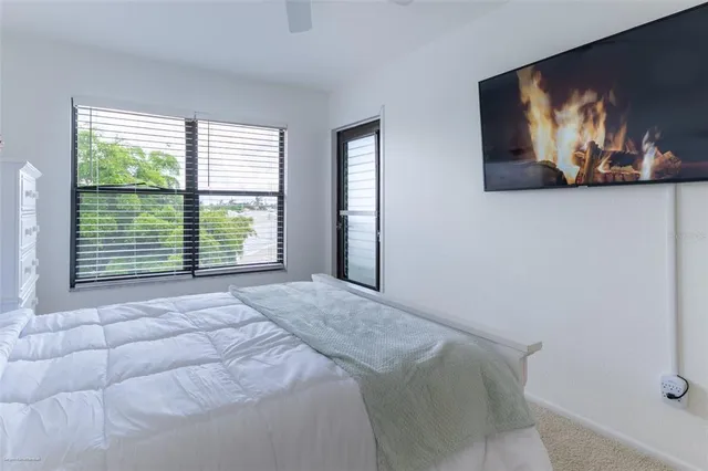 a bedroom with a bed and a painting on the wall