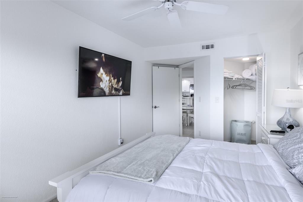 2601 West Marion Avenue, Unit 41C Punta Gorda, FL 33950 - Photo 36 of 43 a bedroom with a bed and a painting on the wall