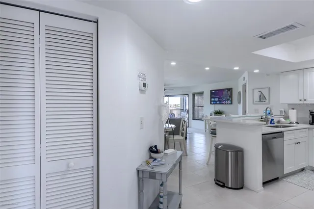a kitchen with a sink stainless steel appliances and cabinets