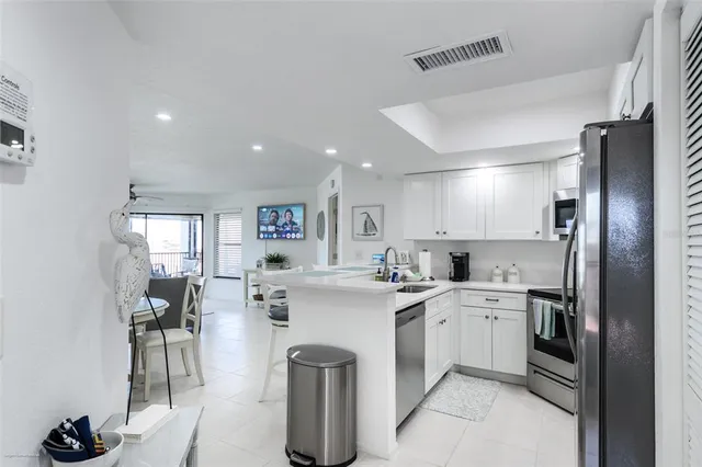a kitchen with appliances a sink and cabinets