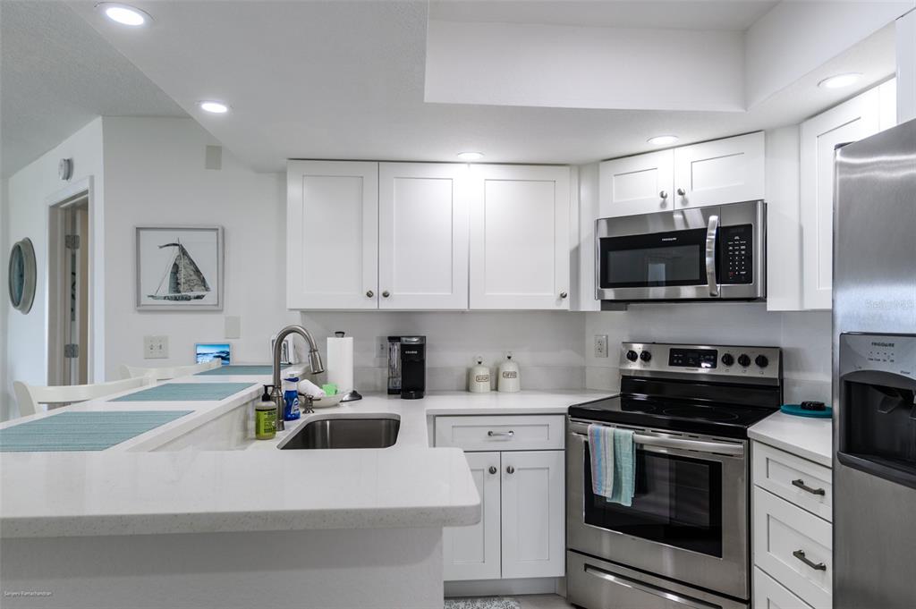 2601 West Marion Avenue, Unit 41C Punta Gorda, FL 33950 - Photo 8 of 43 a kitchen with appliances a sink and cabinets