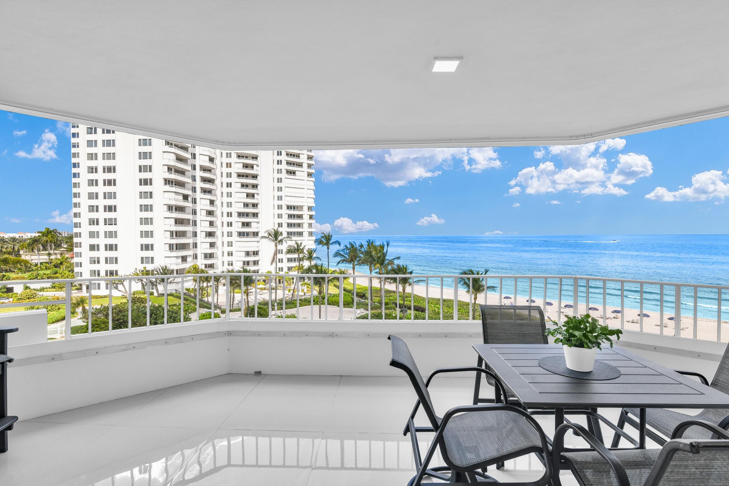 550 South Ocean Boulevard, Unit 605 Boca Raton, FL 33432 - Photo 18 of 51 a balcony with table and chairs