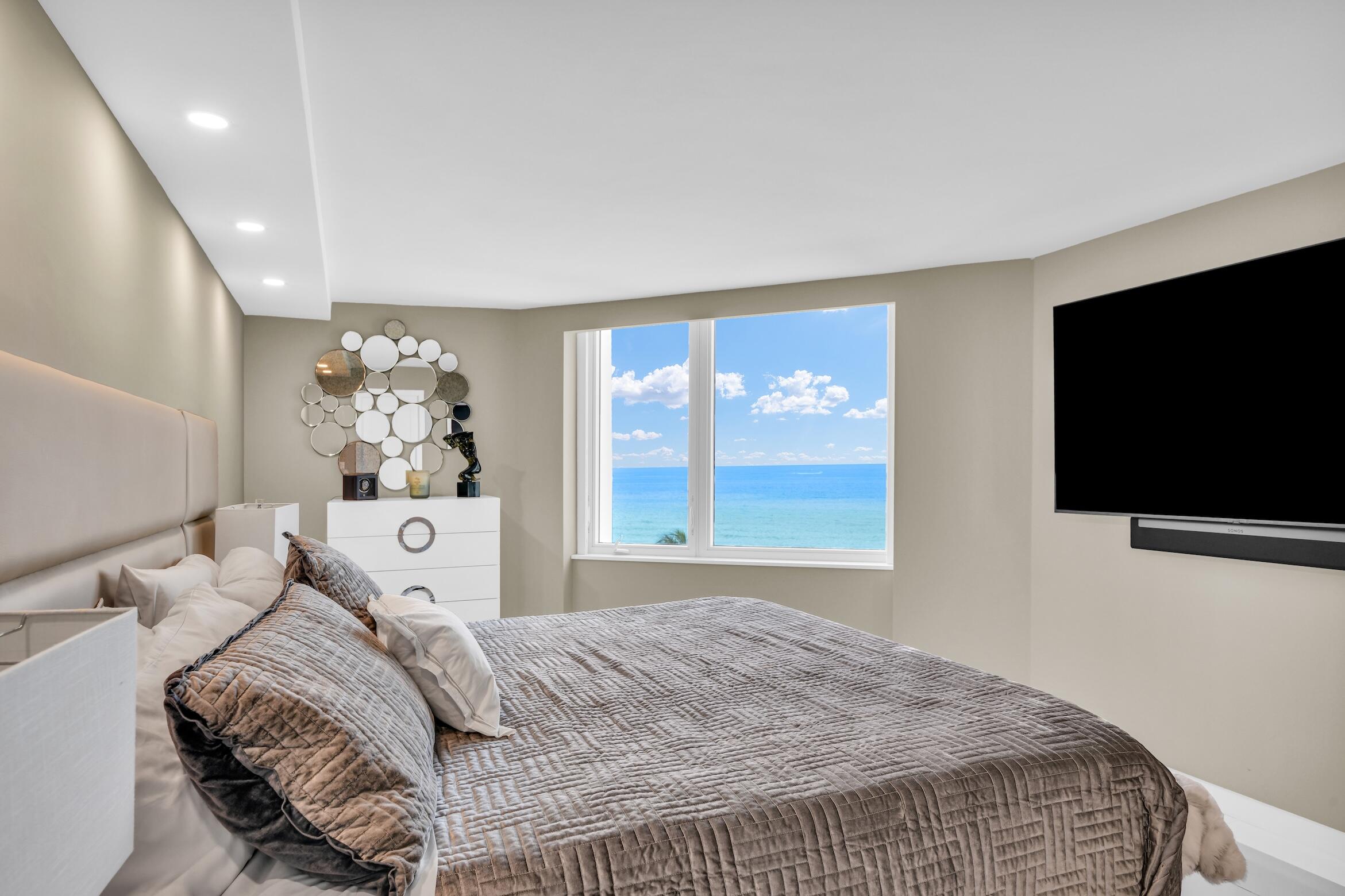 550 South Ocean Boulevard, Unit 605 Boca Raton, FL 33432 - Photo 19 of 51 a bedroom with a bed and a flat screen tv