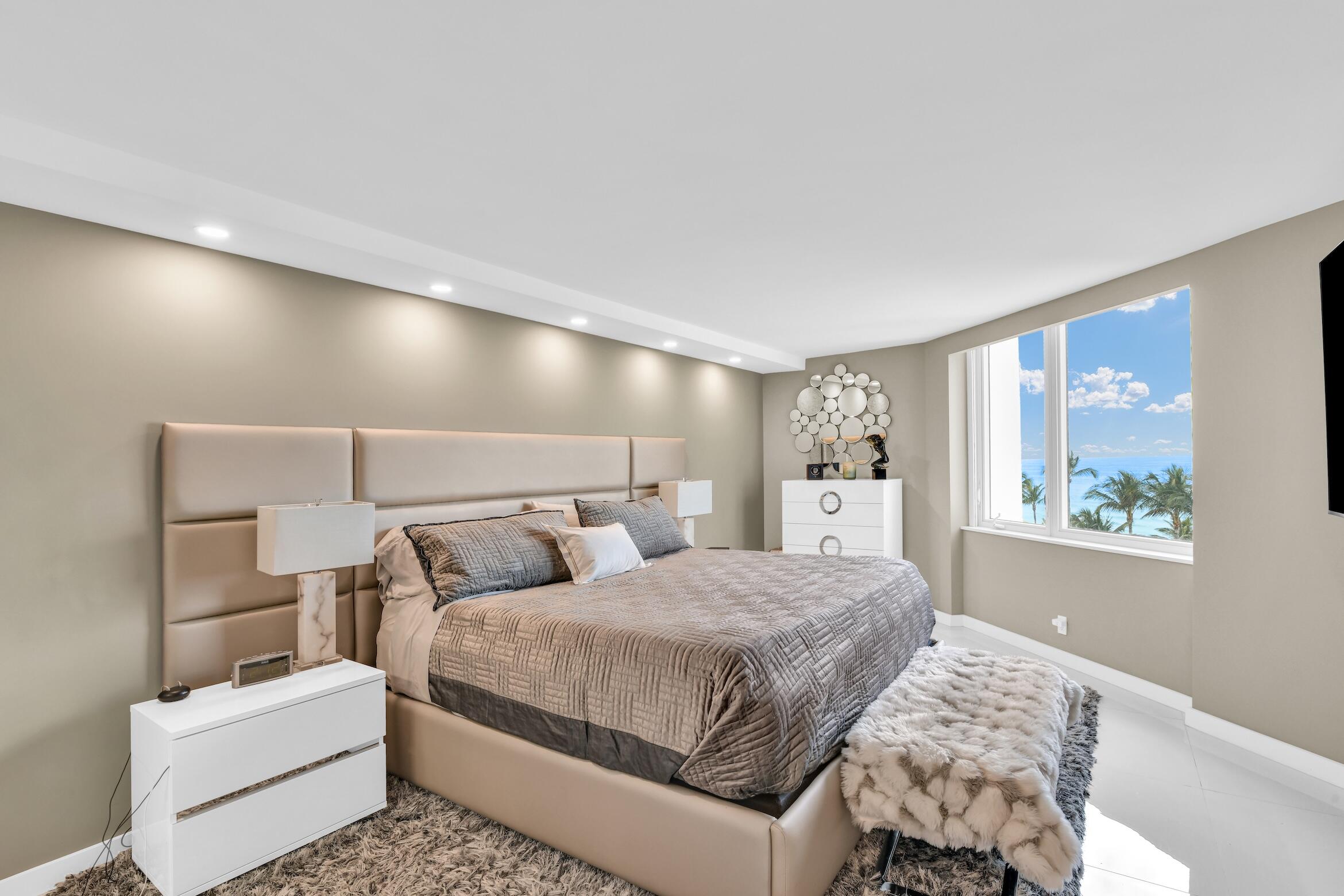 550 South Ocean Boulevard, Unit 605 Boca Raton, FL 33432 - Photo 21 of 51 a bedroom with a white bed and a large window