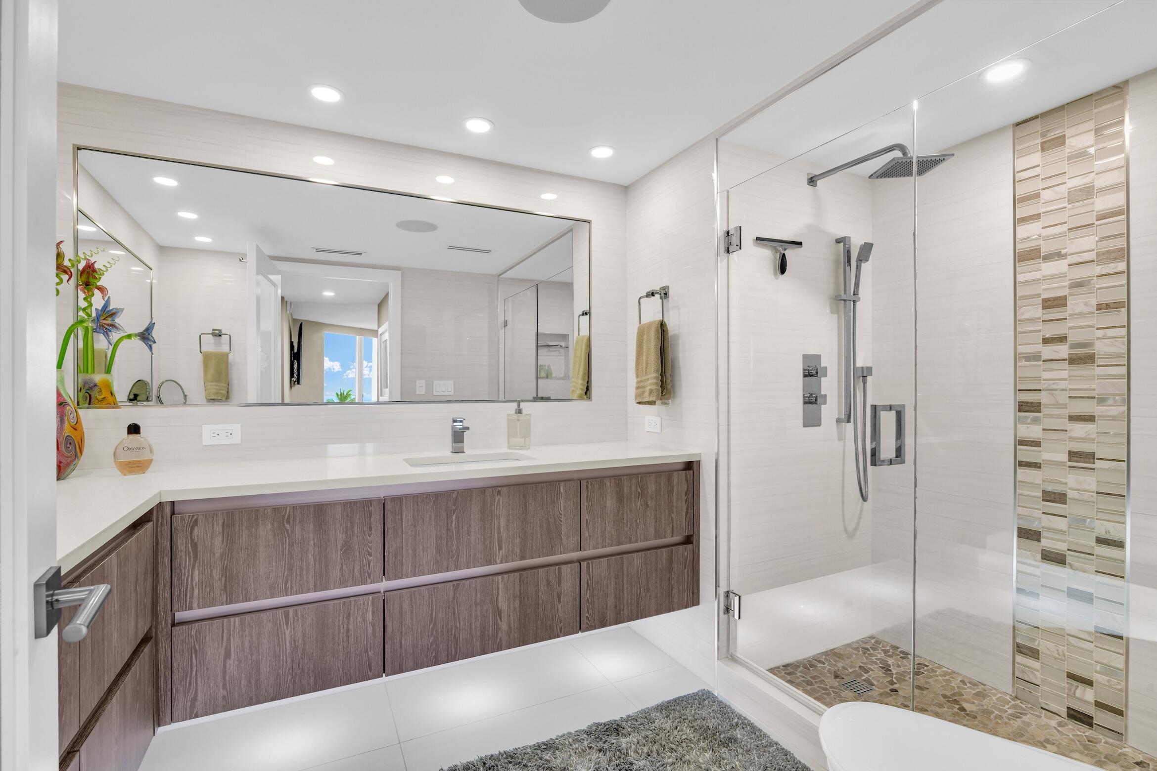 550 South Ocean Boulevard, Unit 605 Boca Raton, FL 33432 - Photo 23 of 51 a spacious bathroom with a double vanity sink mirror and shower