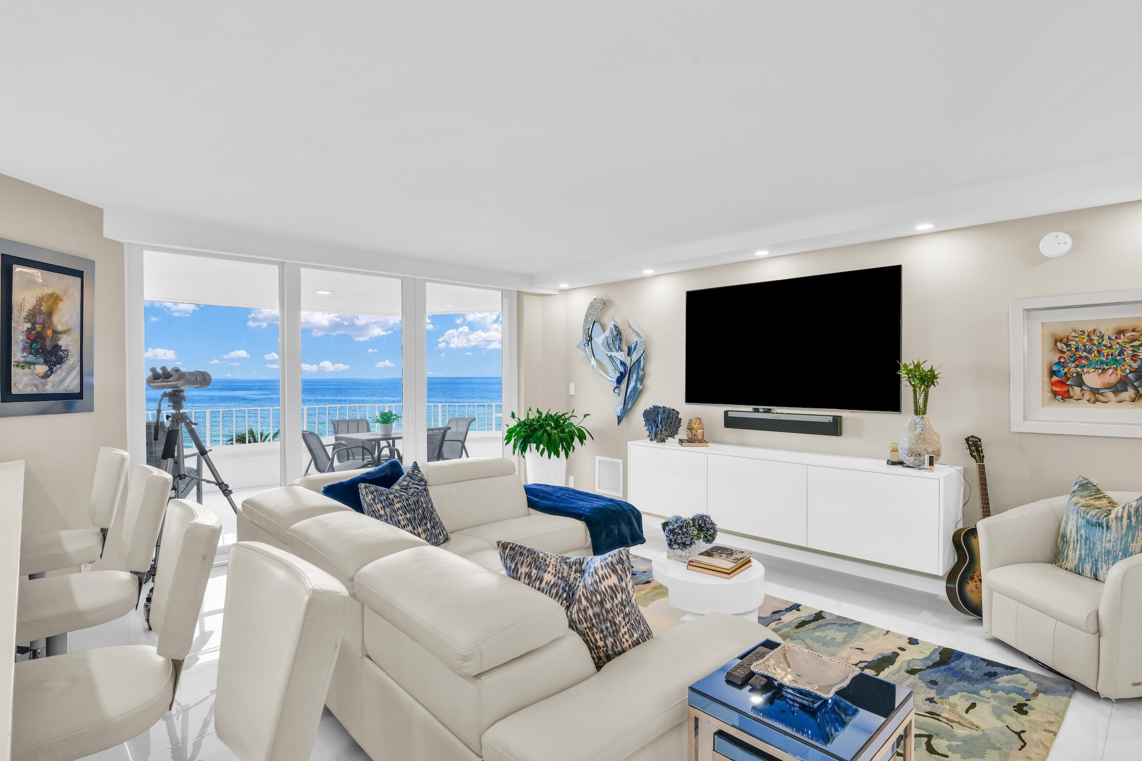 550 South Ocean Boulevard, Unit 605 Boca Raton, FL 33432 - Photo 3 of 51 a living room with furniture a flat screen tv and a large window