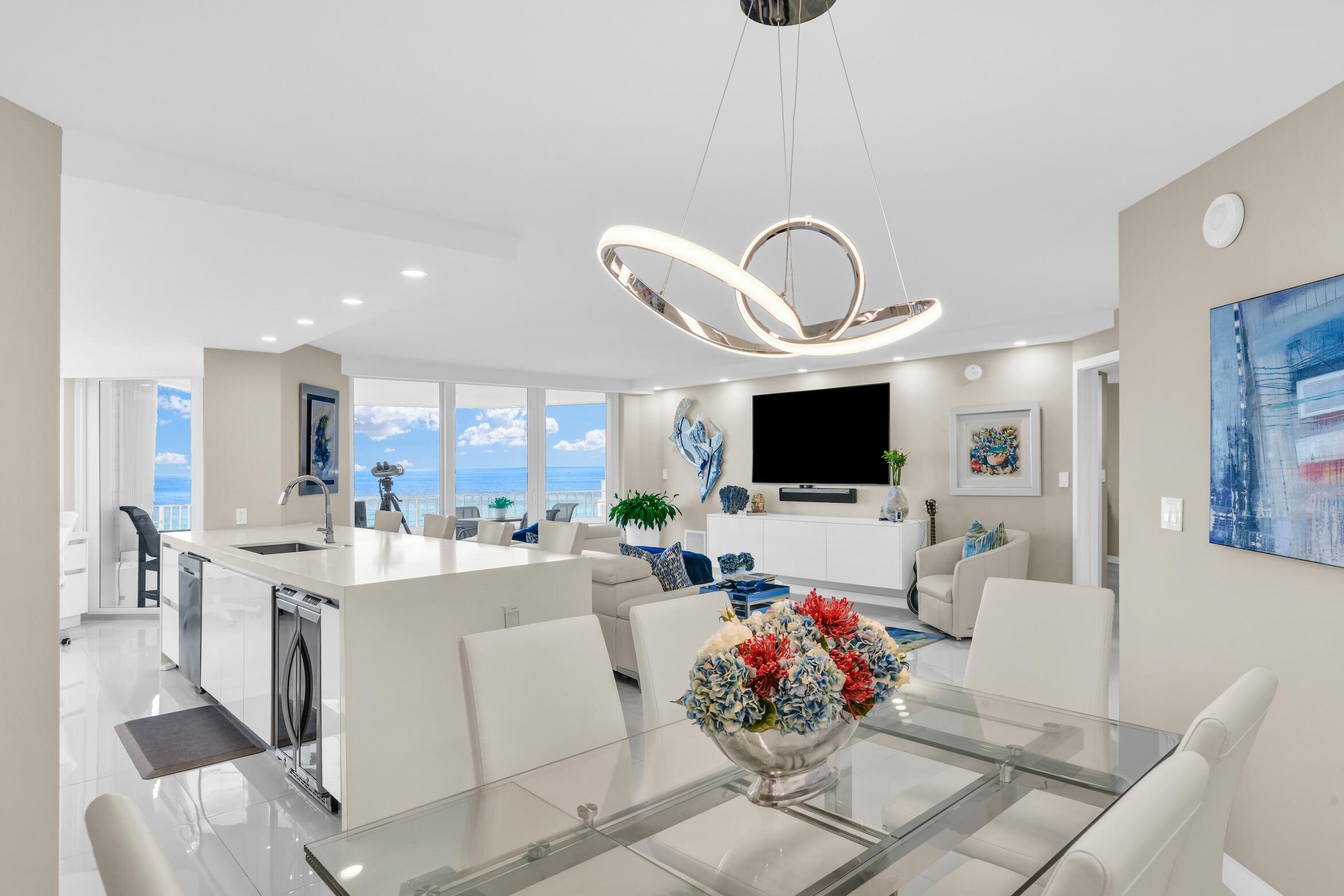 550 South Ocean Boulevard, Unit 605 Boca Raton, FL 33432 - Photo 5 of 51 a living room with furniture a flat screen tv and a large window