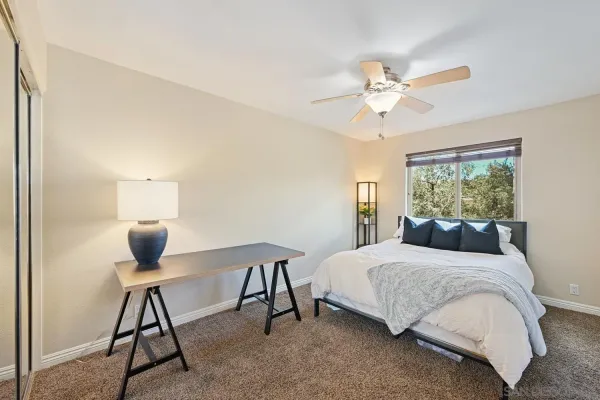 a bedroom with a bed and a window