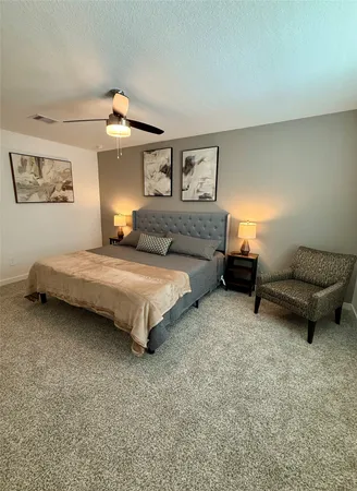 a bedroom with a bed and a couch