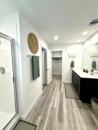 a large white kitchen with a sink and refrigerator