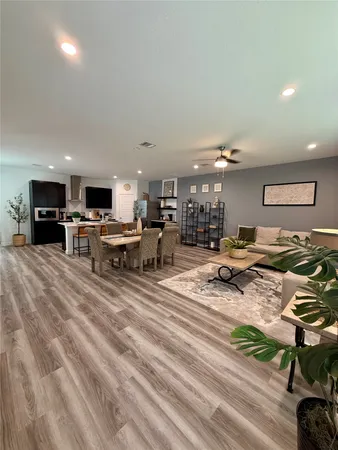 a view of a kitchen with kitchen island stainless steel appliances refrigerator stove microwave and cabinets