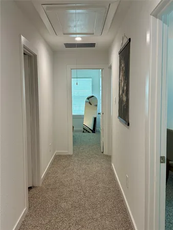 a spacious bedroom with a bed a chair and the couch