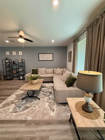 a living room with furniture and a lamp