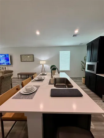 a table with chairs and white appliances