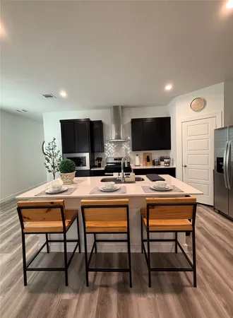 a kitchen with a dining table and chairs