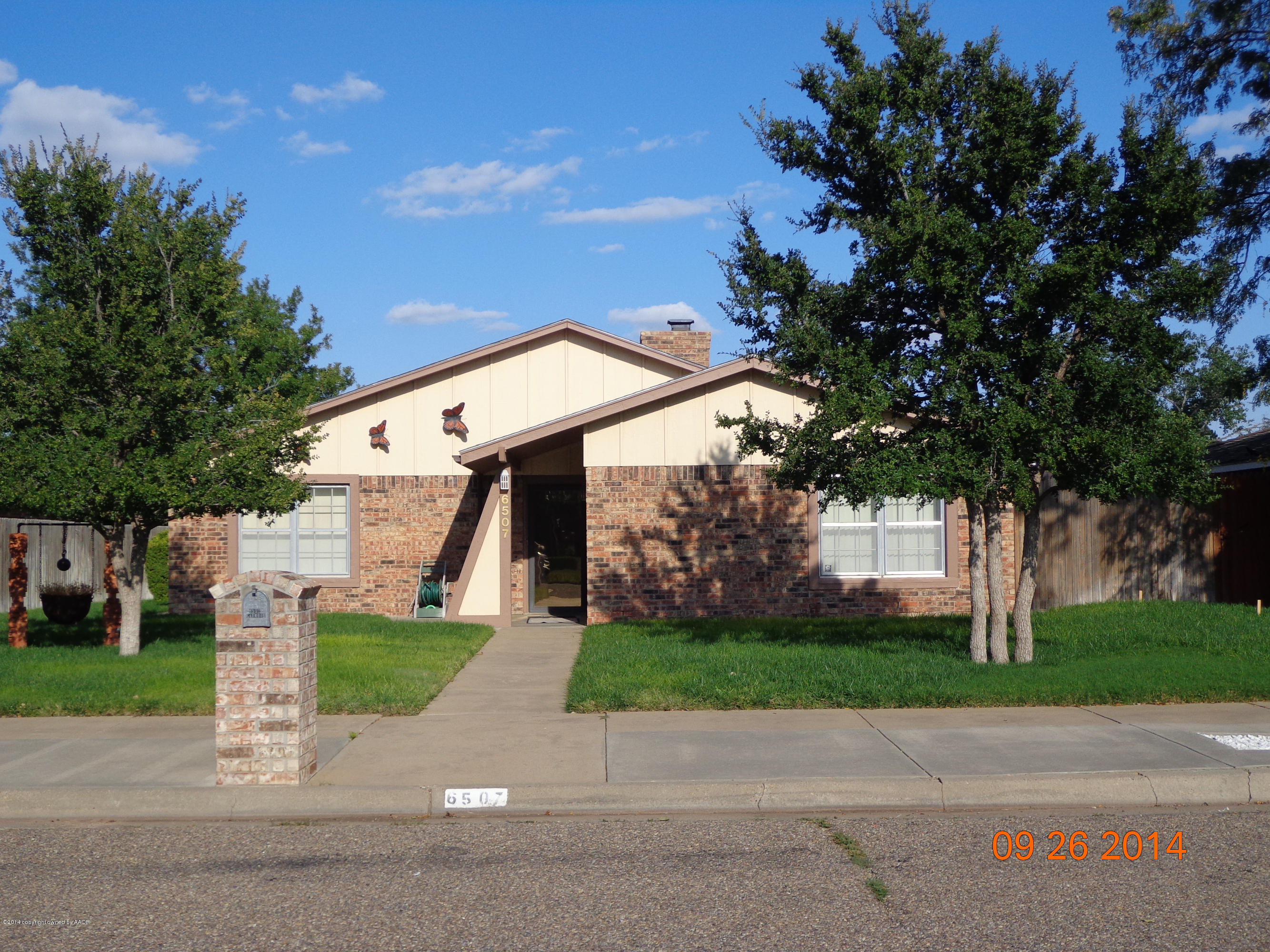 6507 Garwood Road Amarillo, TX 79109 - Photo 2 of 20 a front view of a house with a yard and trees