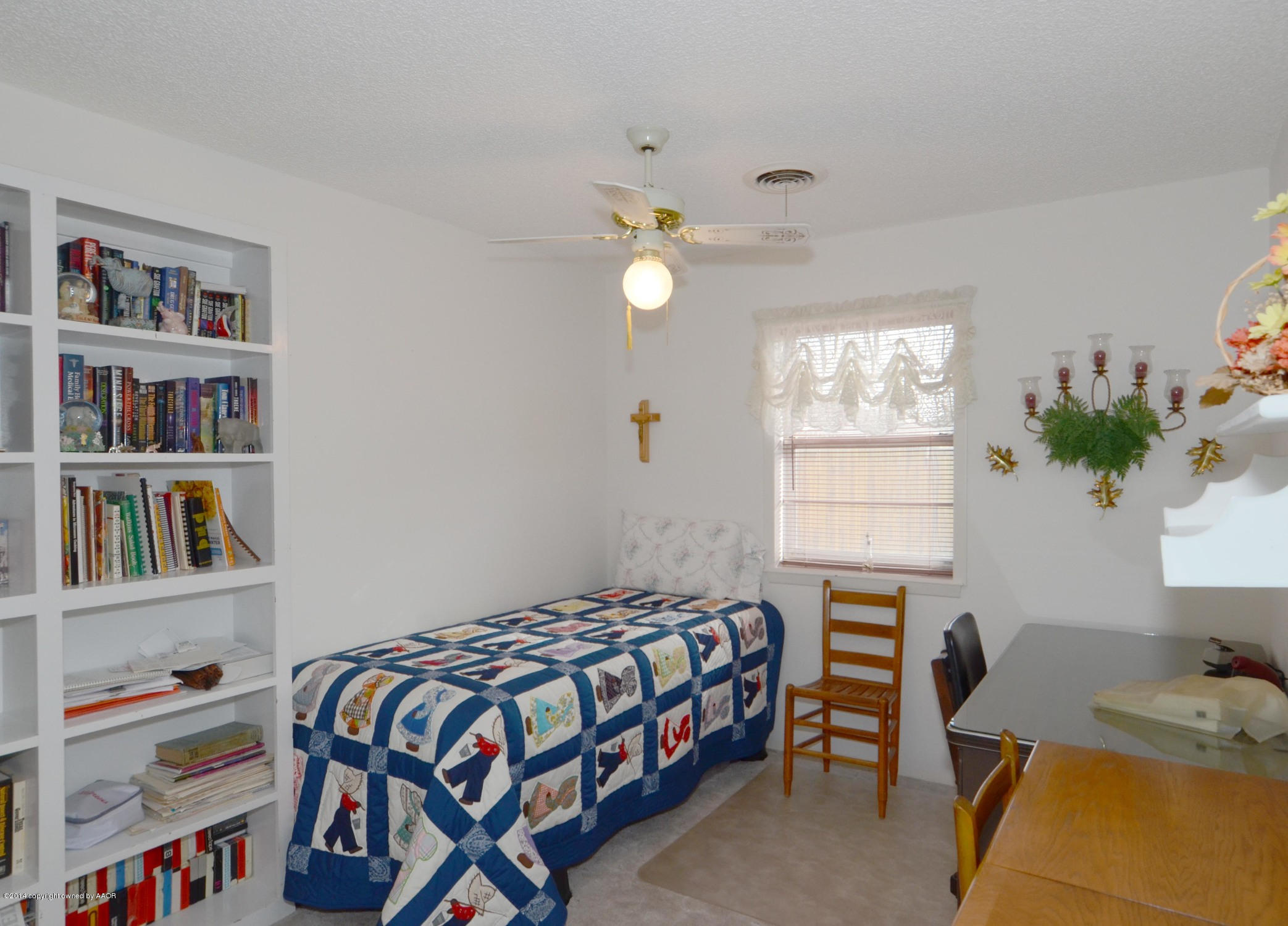 6507 Garwood Road Amarillo, TX 79109 - Photo 14 of 20 a bedroom that has a bed and a bookshelf in it