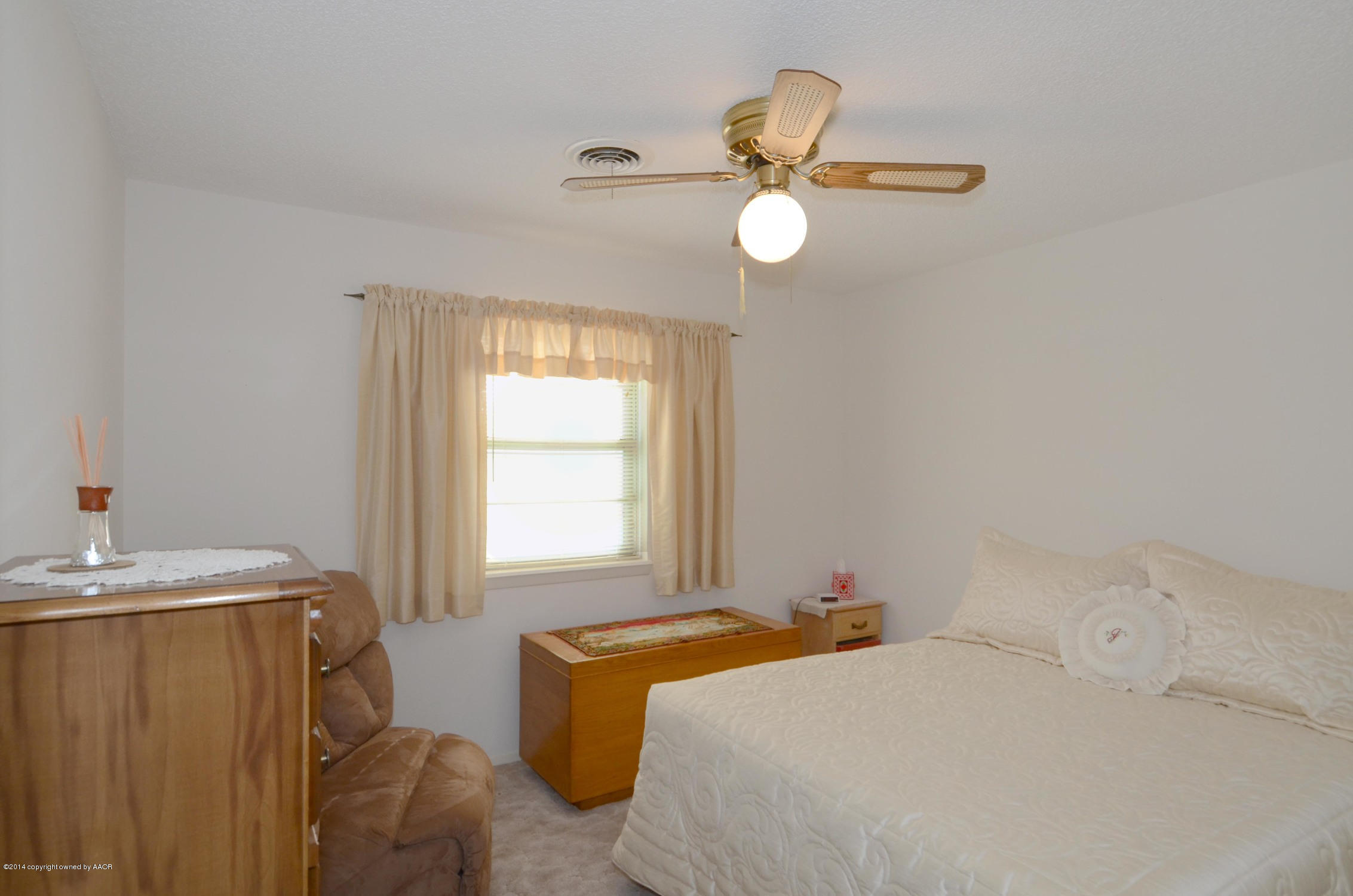 6507 Garwood Road Amarillo, TX 79109 - Photo 16 of 20 a bedroom with a bed and a window