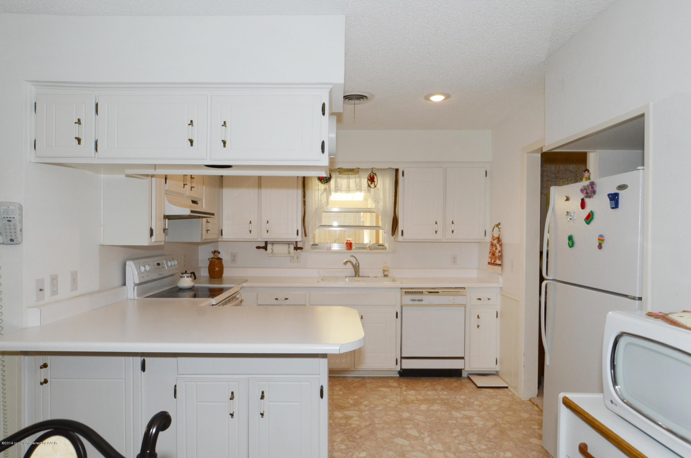 6507 Garwood Road Amarillo, TX 79109 - Photo 9 of 20 a kitchen with a sink white cabinets and stainless steel appliances