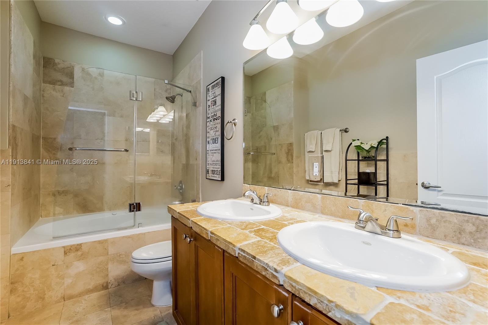 2769 Coconut Avenue, Unit 2769 Coconut Grove, FL 33133 - Photo 11 of 14 a bathroom with a granite countertop sink mirror toilet and bathtub