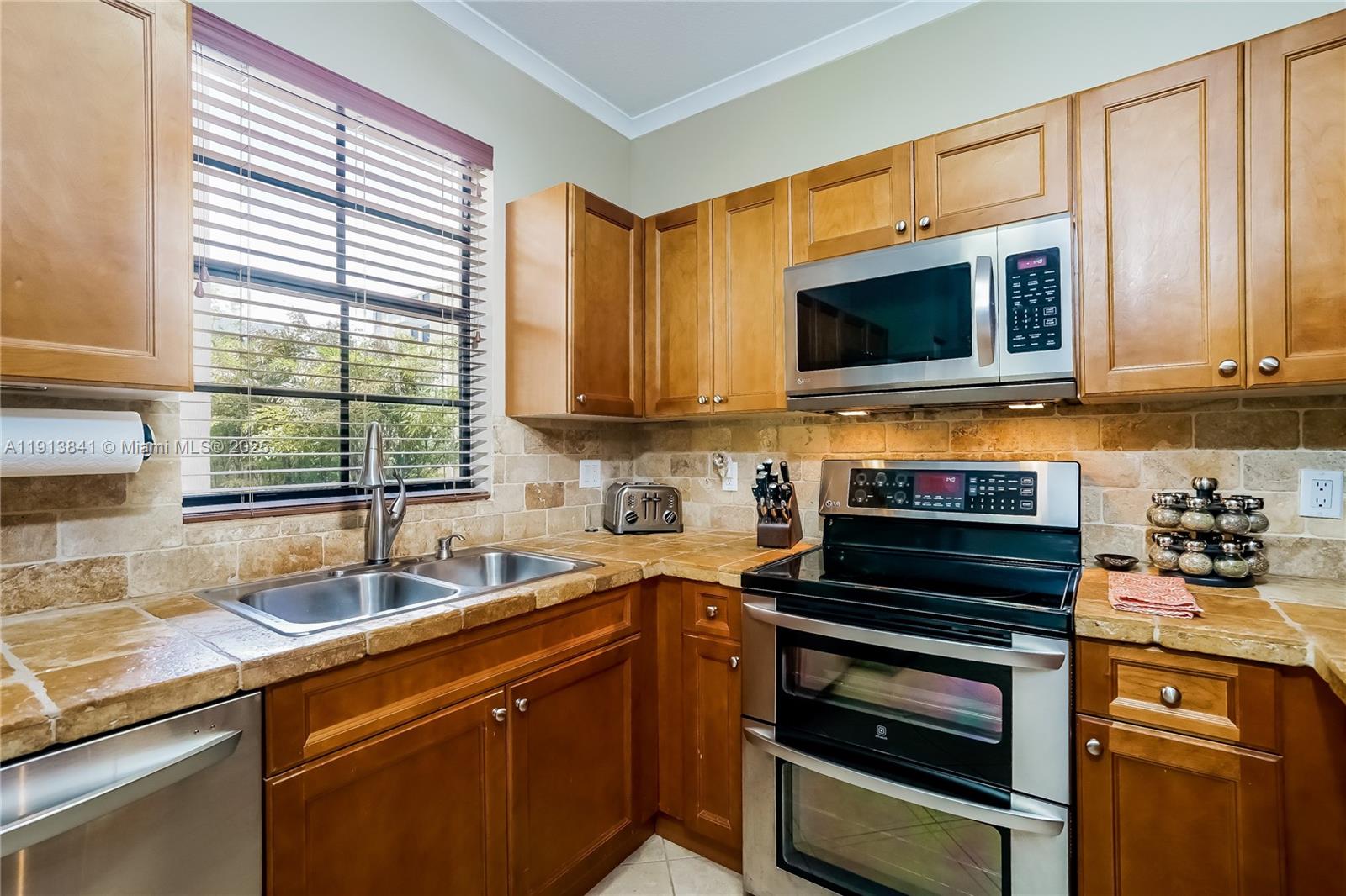 2769 Coconut Avenue, Unit 2769 Coconut Grove, FL 33133 - Photo 8 of 14 a kitchen with a sink stove top oven and cabinets