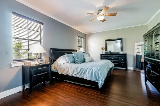 a spacious bedroom with a bed and a chandelier