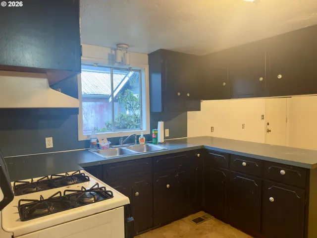 a kitchen that has a sink and a stove