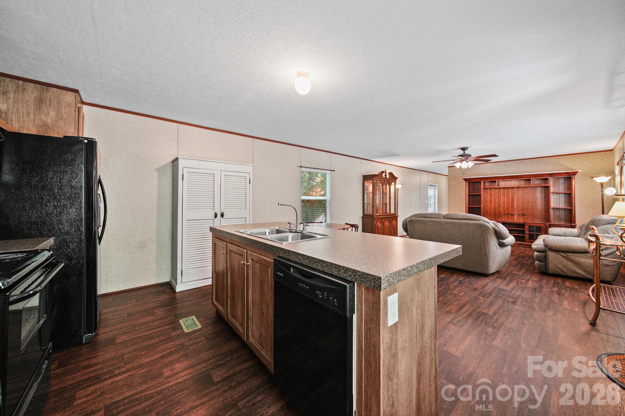 4507 White Store Road Wingate, NC 28174 - Photo 11 of 29 a kitchen with stainless steel appliances granite countertop a stove and a refrigerator
