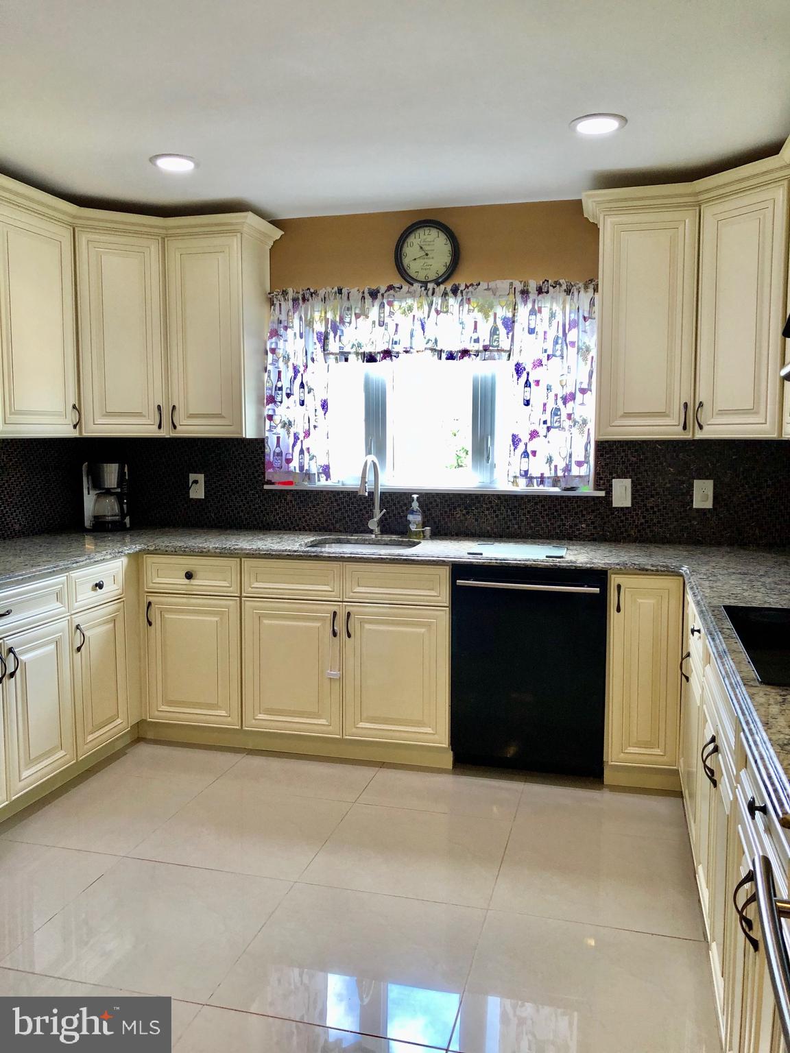 53 Goodturn Road Levittown, PA 19057 - Photo 8 of 42 a kitchen with granite countertop a stove a sink and a microwave