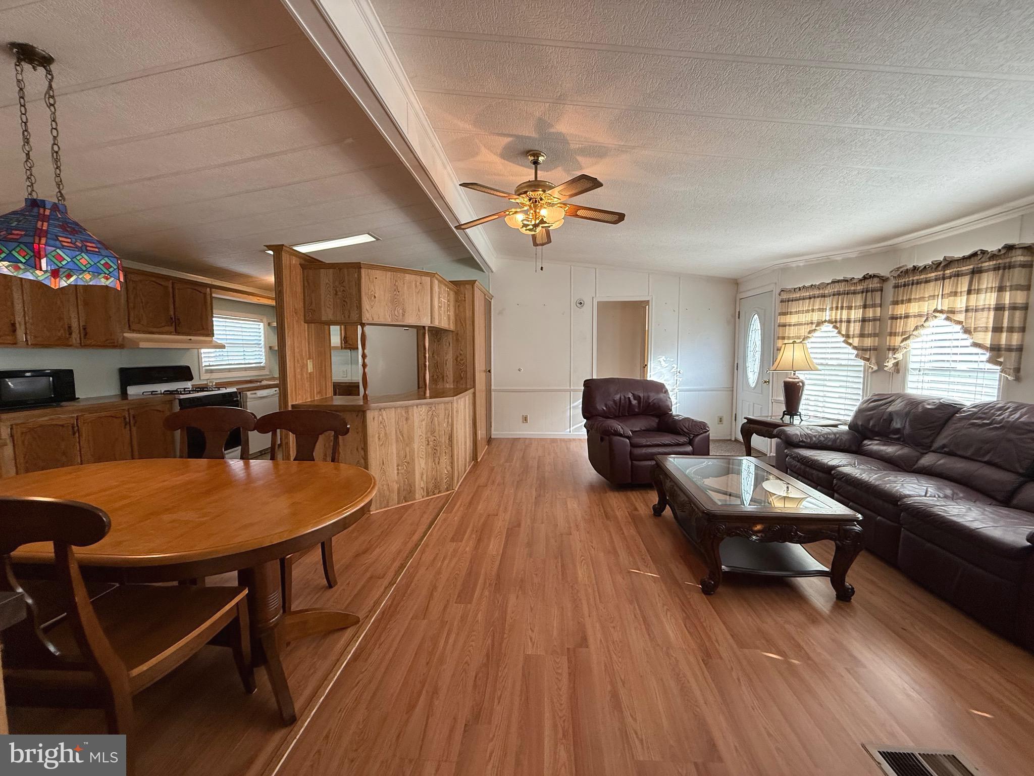 386 Indian Way Buena, NJ 08310 - Photo 25 of 53 a living room with furniture a wooden floor and a window