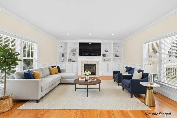 a living room with furniture a fireplace and a flat screen tv