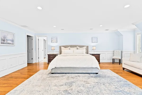 a spacious bedroom with a bed and a couch