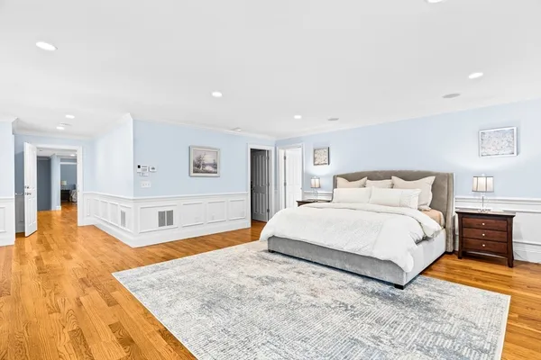 a spacious bedroom with a large bed and a dresser