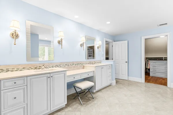 a large bathroom with a sink and a mirror
