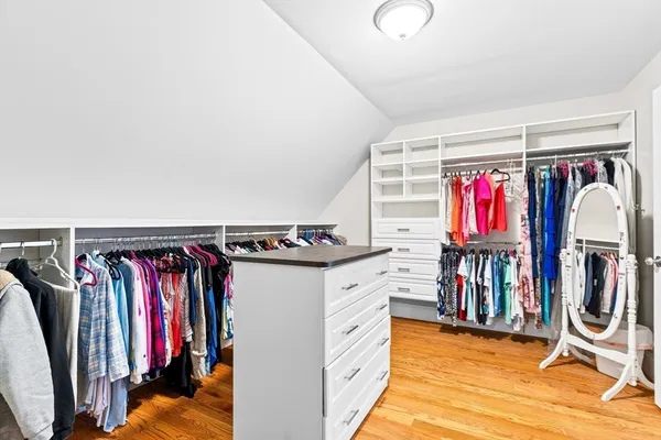 a view of walk in closet with clothes