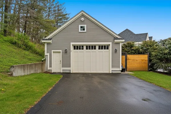 a view of a house with a yard and fence
