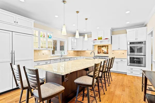 a large kitchen with a table and chairs in it